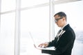 Business man in suit and eyesglasses with laptop