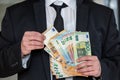 Business man in suit holding euro and dollar banknote for exchange rate. Royalty Free Stock Photo