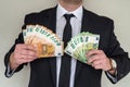 Business man in suit holding euro and dollar banknote for exchange rate. Royalty Free Stock Photo