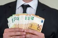 Business man in suit holding euro and dollar banknote for exchange rate. Royalty Free Stock Photo