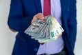 Business man in suit holding euro and dollar banknote for exchange rate Royalty Free Stock Photo