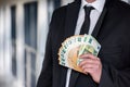 Business man in suit holding euro and dollar banknote for exchange rate. Royalty Free Stock Photo