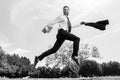 Business man in suit jumping over urban park. Fast business concept. Royalty Free Stock Photo