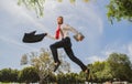 Business man in suit jumping over urban park. Portrait of successful businessman. Fast business concept. Royalty Free Stock Photo