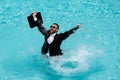 Business man in suit with laptop excited jumping in swimming pool. Funny businessman in suit with computer laptop on the Royalty Free Stock Photo