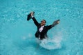 Business man in suit with laptop excited jumping in swimming pool. Funny businessman in suit with computer laptop on the Royalty Free Stock Photo