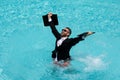 Business man in suit with laptop excited jumping in swimming pool. Funny businessman in suit with computer laptop on the Royalty Free Stock Photo