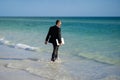 Business man in suit with laptop in sea water. Travel tourism and business concept. Crazy male office employee with