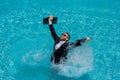 Business man in suit and laptop splash water in swimming pool. Crazy summer business vacation. Funny excited amazed Royalty Free Stock Photo