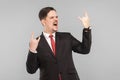 Business man in suit showing rock sign and roar Royalty Free Stock Photo