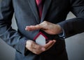 Business man in suit using hands covering and protecting house Royalty Free Stock Photo