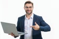 Business man in suit working on laptop in studio. Man checking email on laptop, writing message in social network, using