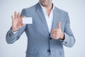 business man in Suits show thumb up and holding blank white credit card mockup isolated on white background with clipping path of Royalty Free Stock Photo