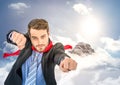 Business man superhero with hands out against mountain peak with clouds Royalty Free Stock Photo