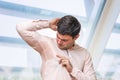 Business man with sweating under armpit in office