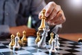 Business man take a king figure checkmate on the chess board game - strategy, management or leadership success concept Royalty Free Stock Photo