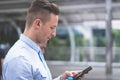 Business man taking a break drinking water and using mobile phone Royalty Free Stock Photo