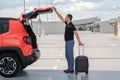 Business man taking out suitcase from car trunk Royalty Free Stock Photo