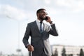 Business Man Talking On Cellphone Standing With Travel Suitcase Outdoors Royalty Free Stock Photo