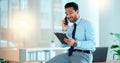 Business man talking on a phone while browsing on a digital tablet in an office. Dedicated sales executive and young Royalty Free Stock Photo