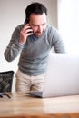 Business man talking on phone and looking at computer Royalty Free Stock Photo