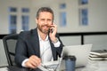 Business man talking on phone at office workplace. Business talk. Hispanic business man working online. Mature business Royalty Free Stock Photo