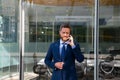 Business man talking on phone. Portrait of cheerful Businessman office worker talking on mobile phone while standing