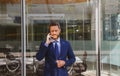 Business man talking on phone. Portrait of cheerful Businessman office worker talking on mobile phone while standing