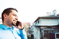 Business man talking on phone. Young guy calling by cellphone smiling Royalty Free Stock Photo