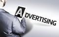 Business man with the text Advertising in a concept image