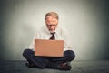 Business man thinking and sitting on the floor working on computer Royalty Free Stock Photo