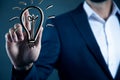 Business man touching a light bulb on touch screen Royalty Free Stock Photo