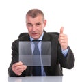 Business man with transparent pannel shows thumb up