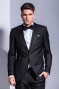 Business man in tuxedo holding his hand in pocket. Royalty Free Stock Photo