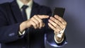 A business man typing on cell phone. Closeup