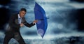 Business man with umbrella blocking wind against stormy sky and bokeh Royalty Free Stock Photo