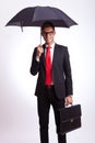 Business man with umbrella and suitcase Royalty Free Stock Photo