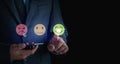 Business man use smartphone choosing green happy smile face icon. feedback rating and positive customer review experience, satisfa