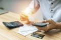 Business man using digital mobile phone scan and payment online with credit card bill on desk in home office