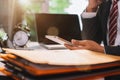 Business man using digital tablet analyzes business data, busy working on laptop computer with tablet. Royalty Free Stock Photo