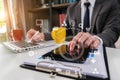 Business man using digital tablet analyzes business data working on laptop computer with tablet on office desk. Royalty Free Stock Photo