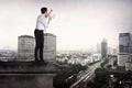 Business man using megaphone talking to the city Royalty Free Stock Photo