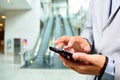 Business Man Using Mobile while going down Escalator Royalty Free Stock Photo