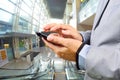 Business Man Using Mobile while going down Escalator Royalty Free Stock Photo