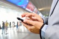 Business Man using Mobile Phone in Modern Train Station Royalty Free Stock Photo