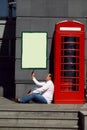 Business man using mobile phone red classic English telephone bo Royalty Free Stock Photo