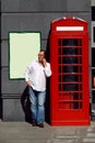 Business man using mobile phone red classic English telephone bo Royalty Free Stock Photo