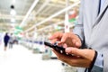 Business Man using mobile phone while shopping in supermarket. Royalty Free Stock Photo