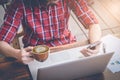 Business man using smart phone laptop computer and holding a cup of coffee Royalty Free Stock Photo