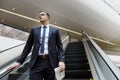 Business Man Walking Down Escalator Concept Royalty Free Stock Photo